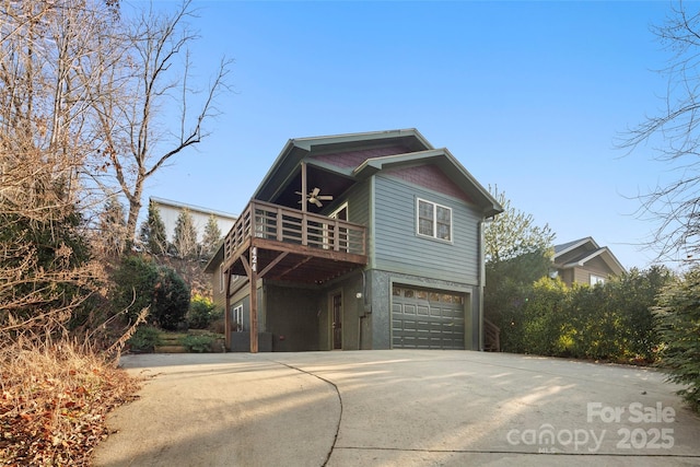 view of side of home featuring ceiling fan, a garage, and a balcony