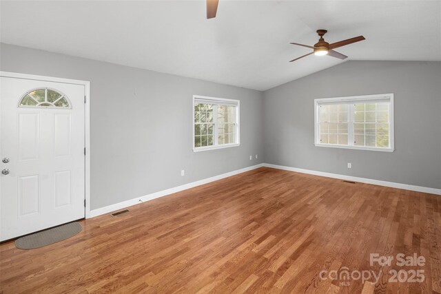 foyer with hardwood / wood-style flooring, ceiling fan, and lofted ceiling