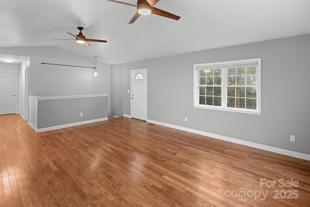 unfurnished living room featuring hardwood / wood-style floors, vaulted ceiling, and ceiling fan