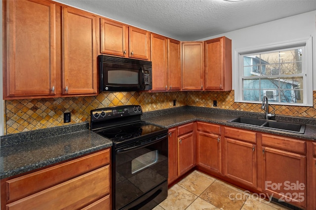 kitchen featuring black appliances, tasteful backsplash, sink, and a textured ceiling