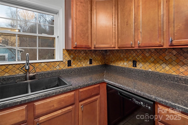 kitchen with black dishwasher, tasteful backsplash, dark stone countertops, and sink