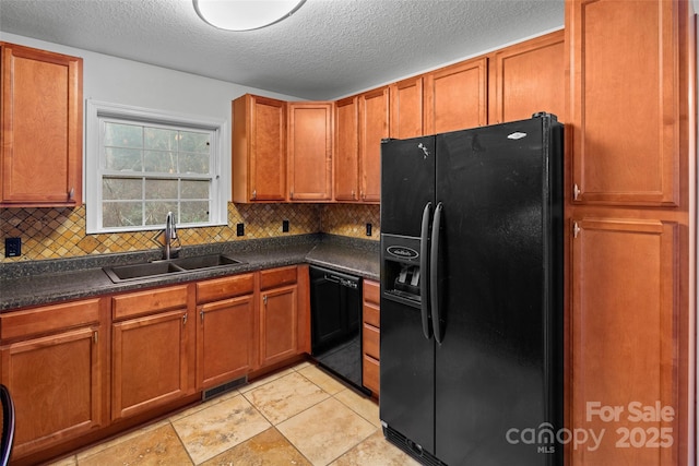 kitchen with decorative backsplash, sink, black appliances, and a textured ceiling