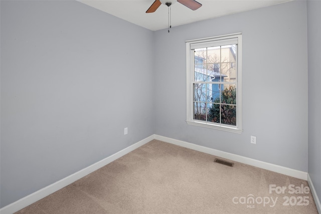 empty room featuring carpet flooring and ceiling fan