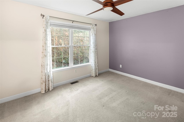 spare room featuring carpet floors and ceiling fan