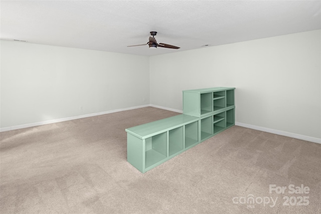 spare room featuring ceiling fan and carpet