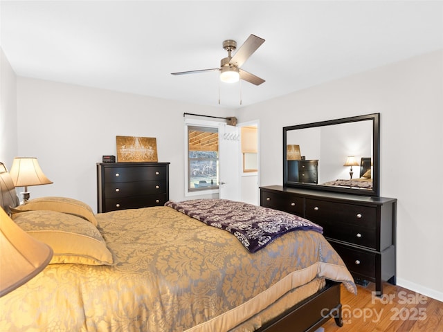 bedroom with ceiling fan and wood-type flooring