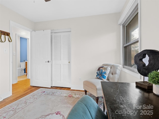 sitting room featuring hardwood / wood-style floors and ceiling fan