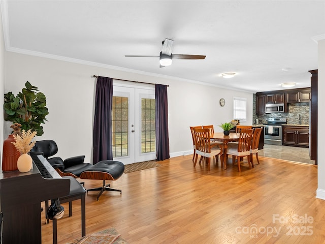 dining area with french doors, light wood-type flooring, ceiling fan, and ornamental molding