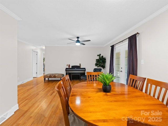 dining room with ceiling fan, light hardwood / wood-style floors, and ornamental molding