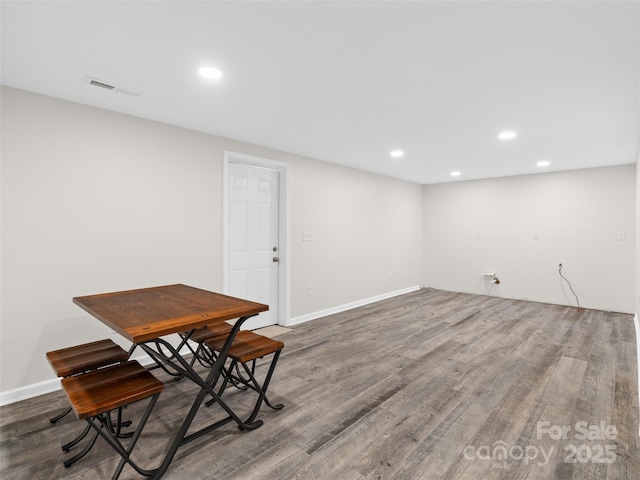 dining room with dark hardwood / wood-style flooring