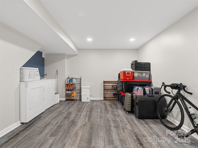 basement with washing machine and dryer and hardwood / wood-style floors