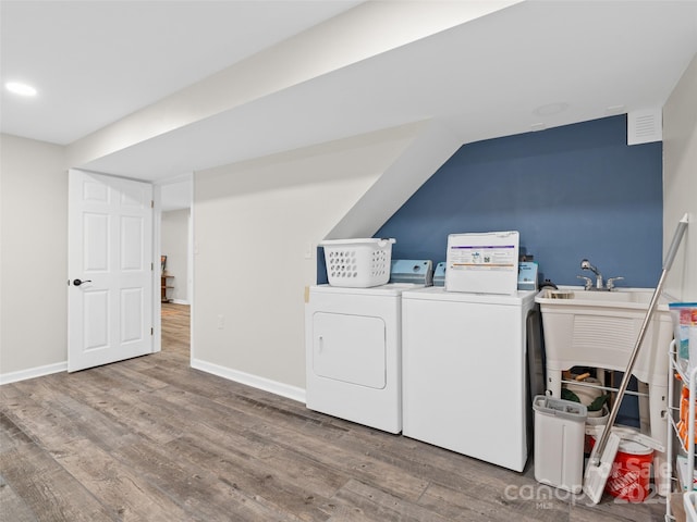 laundry area with hardwood / wood-style floors and washer and dryer