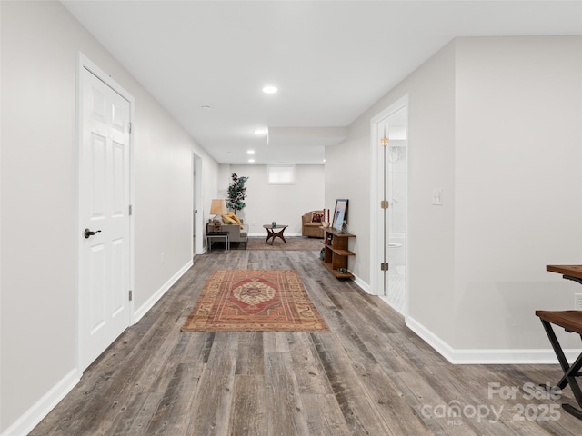 hallway with hardwood / wood-style flooring