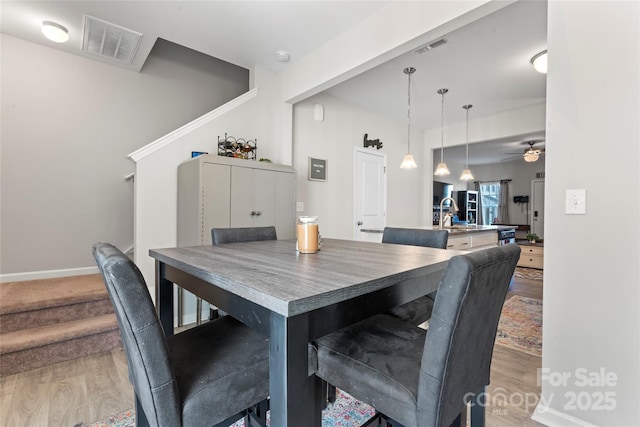 dining space featuring ceiling fan and hardwood / wood-style floors