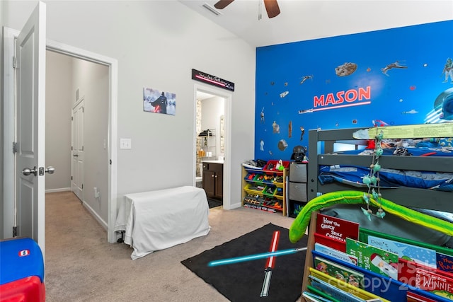 carpeted bedroom with ceiling fan and ensuite bath