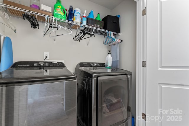 washroom with washing machine and clothes dryer