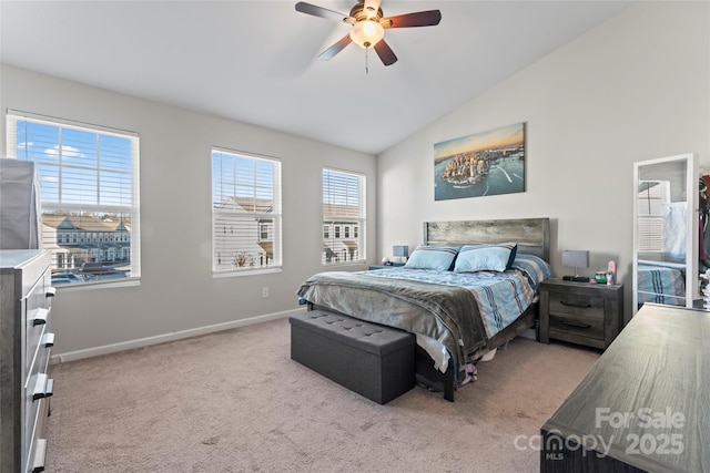 carpeted bedroom with ceiling fan and vaulted ceiling