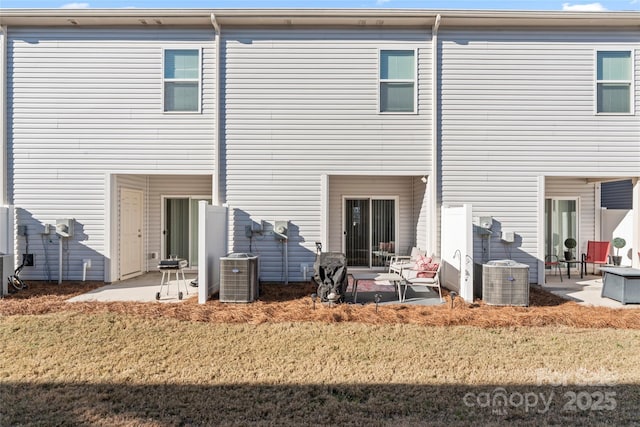 back of house with a lawn, cooling unit, and a patio