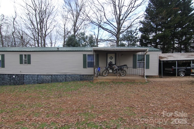 view of front of property with a carport and a porch