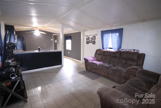 living room with ceiling fan and sink