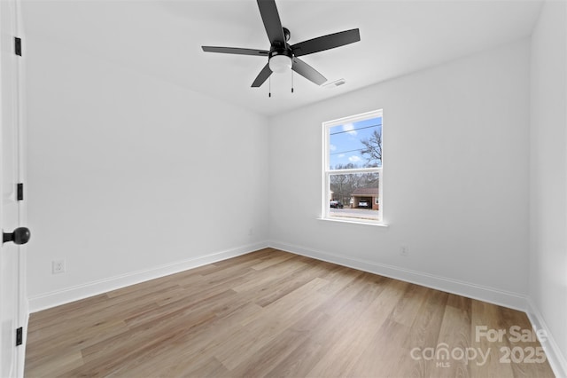 unfurnished room with light wood-style floors, visible vents, ceiling fan, and baseboards