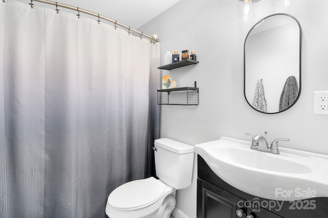 bathroom featuring toilet and vanity