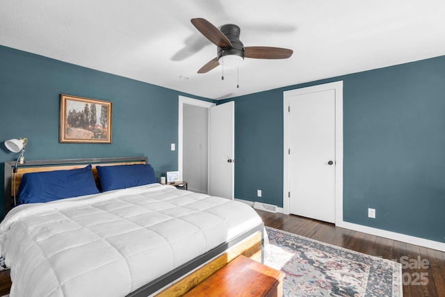 bedroom with dark wood-type flooring and ceiling fan