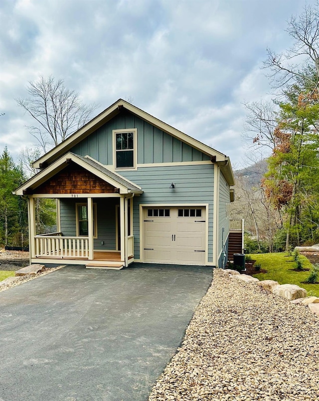 view of front facade with a porch and a garage