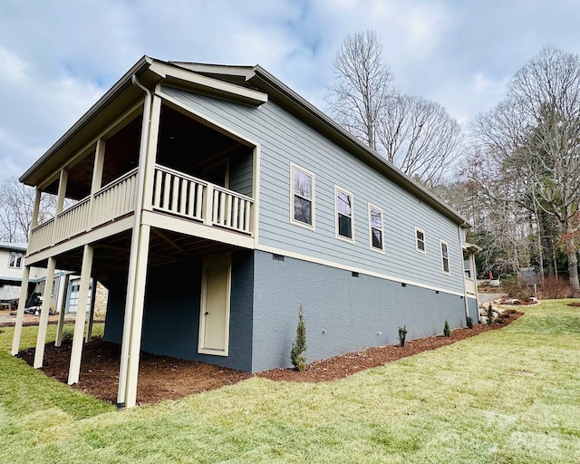 rear view of house featuring a yard and a deck