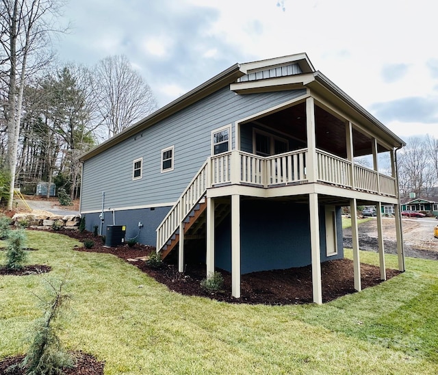 back of house featuring a lawn, central air condition unit, and a deck