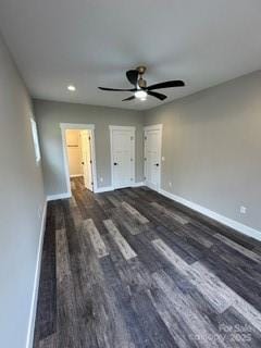 unfurnished bedroom featuring ceiling fan and dark wood-type flooring