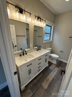 bathroom with vanity, hardwood / wood-style flooring, and toilet