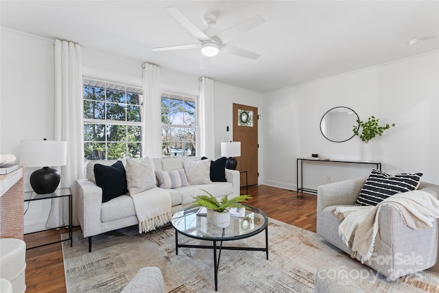 living room featuring wood finished floors, a ceiling fan, and baseboards