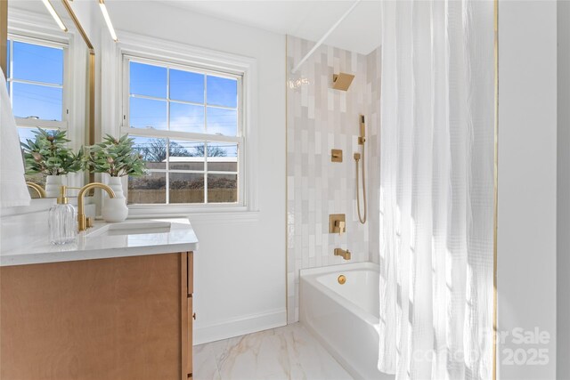 full bathroom featuring marble finish floor, shower / bathtub combination with curtain, baseboards, and vanity