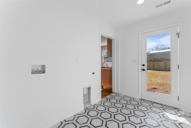 interior space with laundry area, baseboards, visible vents, hookup for a washing machine, and hookup for an electric dryer