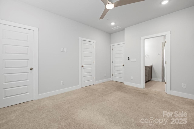 unfurnished bedroom with light carpet, ceiling fan, and ensuite bathroom