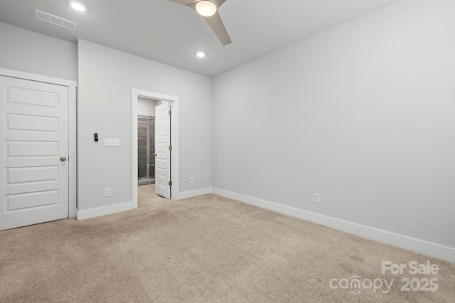 unfurnished bedroom with ceiling fan, light colored carpet, and a closet