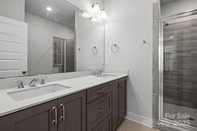 bathroom featuring tile patterned floors, vanity, and an enclosed shower