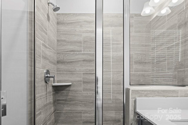 bathroom featuring an enclosed shower and vanity