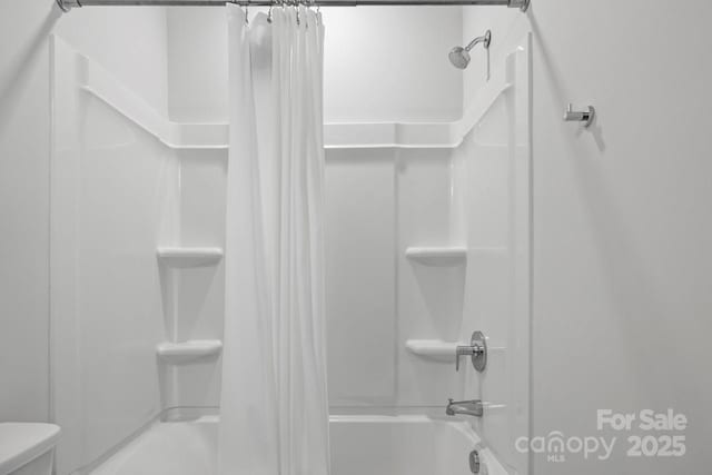 bathroom with toilet and shower / tub combo with curtain