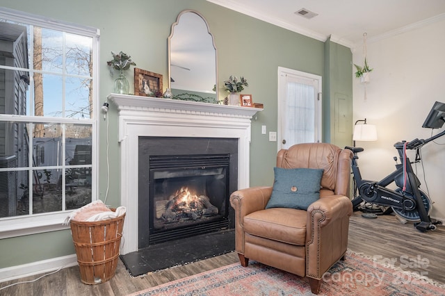 living area featuring crown molding and hardwood / wood-style floors