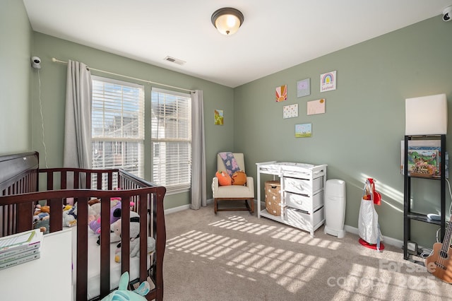 carpeted bedroom featuring a crib and multiple windows