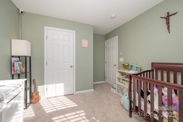 carpeted bedroom featuring a crib