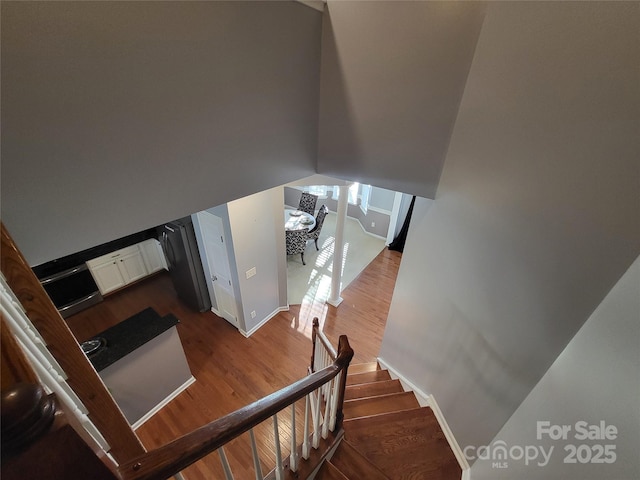 stairway featuring wood-type flooring