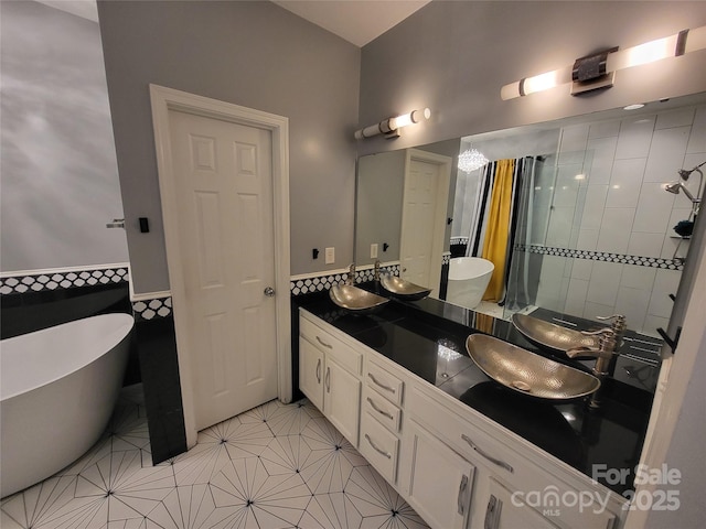 bathroom featuring vanity, tile patterned floors, and a tub