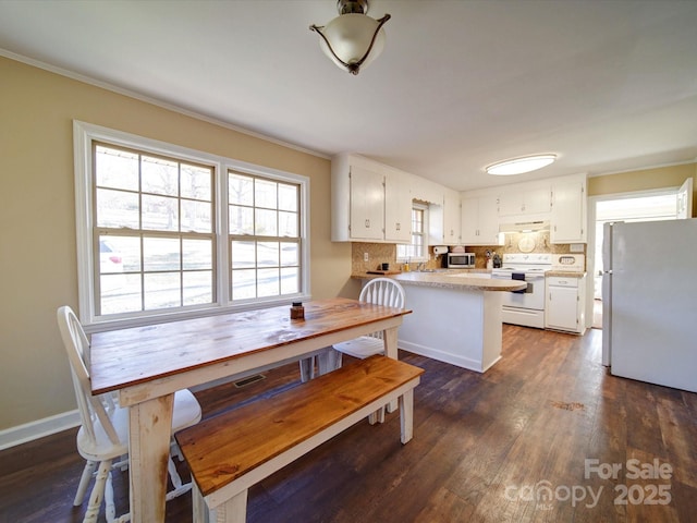 dining room featuring dark hardwood / wood-style flooring and ornamental molding