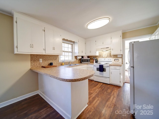 kitchen featuring kitchen peninsula, white appliances, extractor fan, dark wood-type flooring, and white cabinetry