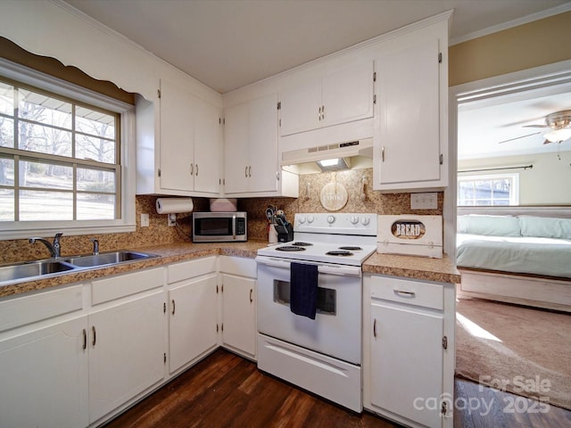 kitchen featuring custom exhaust hood, white cabinets, electric stove, sink, and decorative backsplash