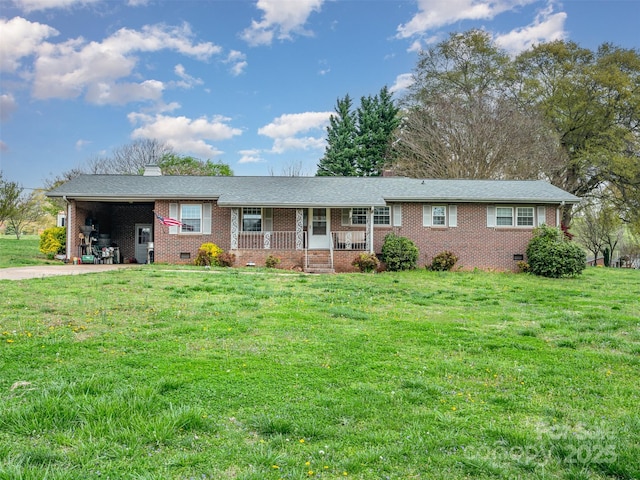 ranch-style home featuring covered porch and a front yard