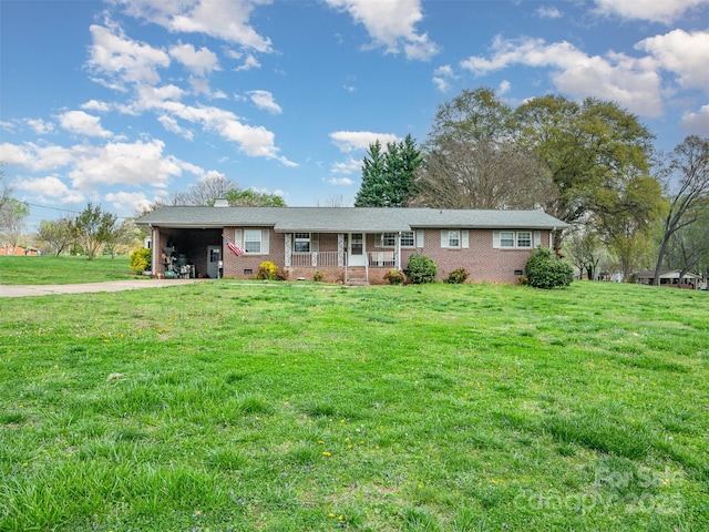 single story home featuring a porch, a front yard, and a carport